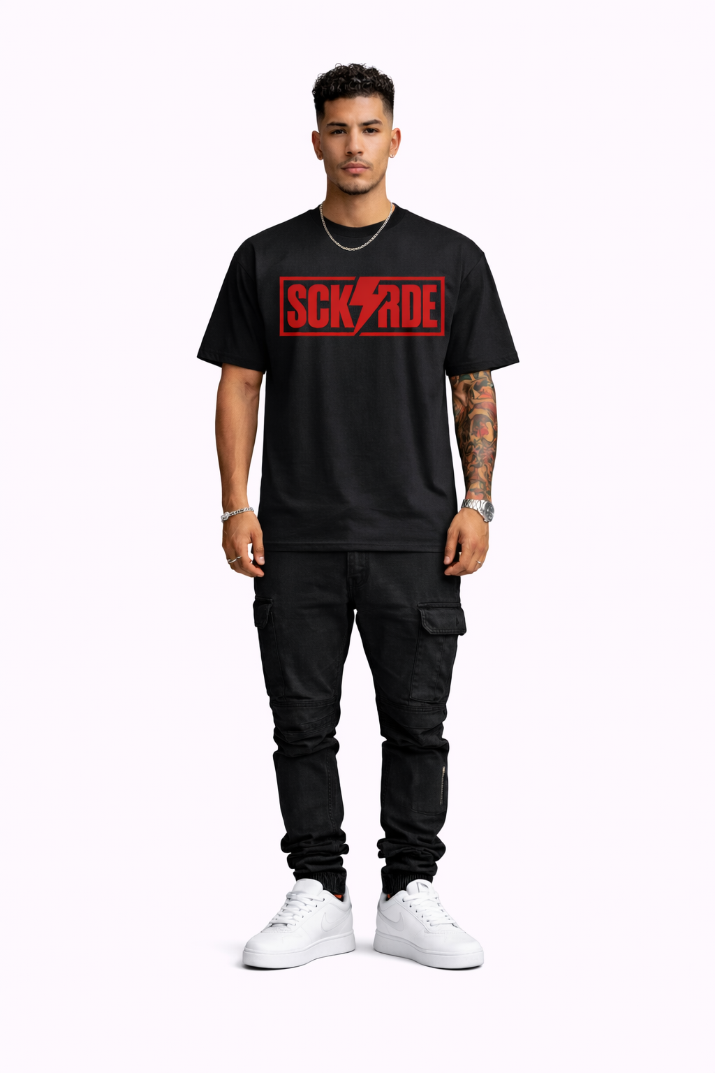 Man wearing a black t-shirt with red logo and black pants on a white background