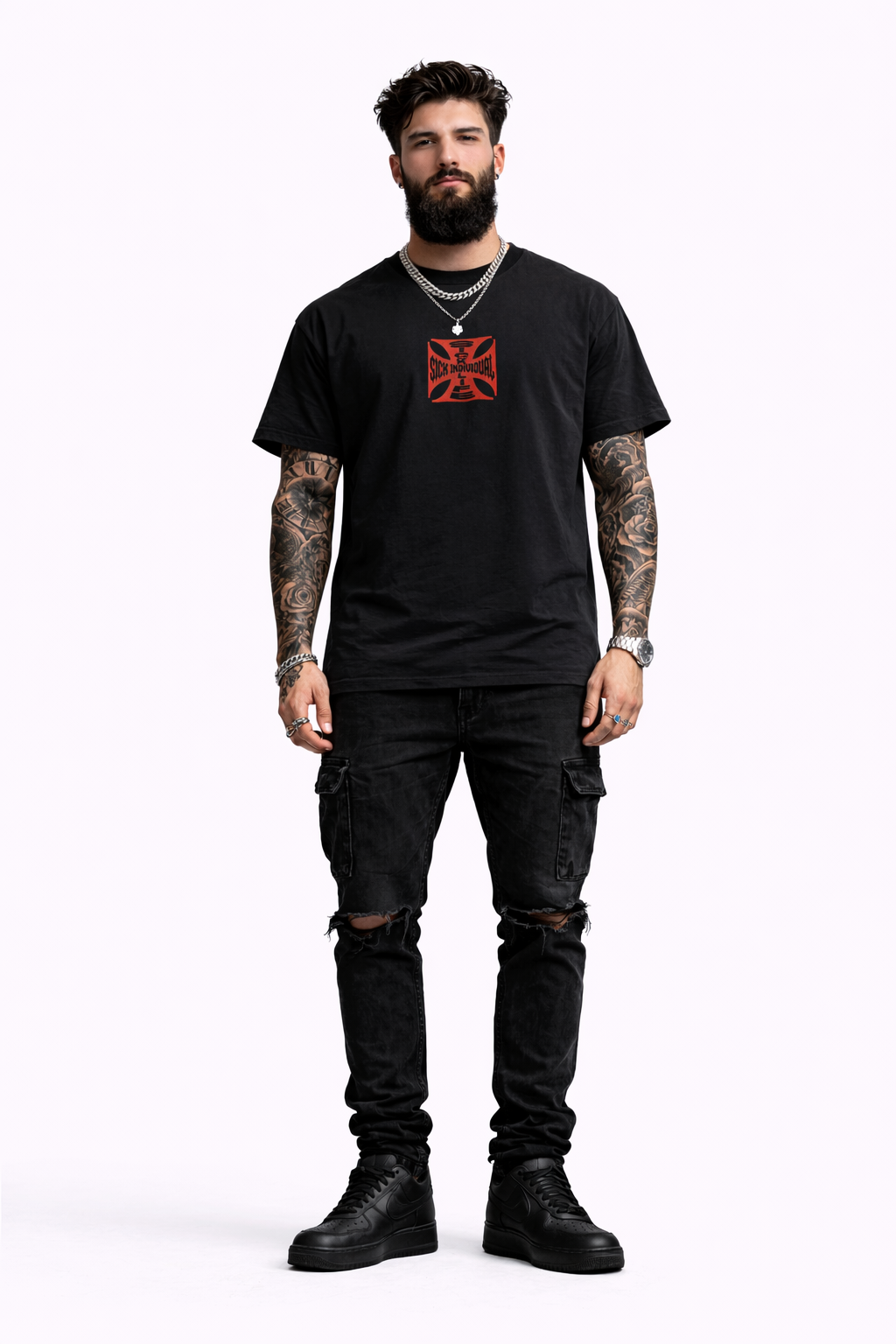 Man wearing a black t-shirt with a red and white logo, black pants, and black boots on a white background