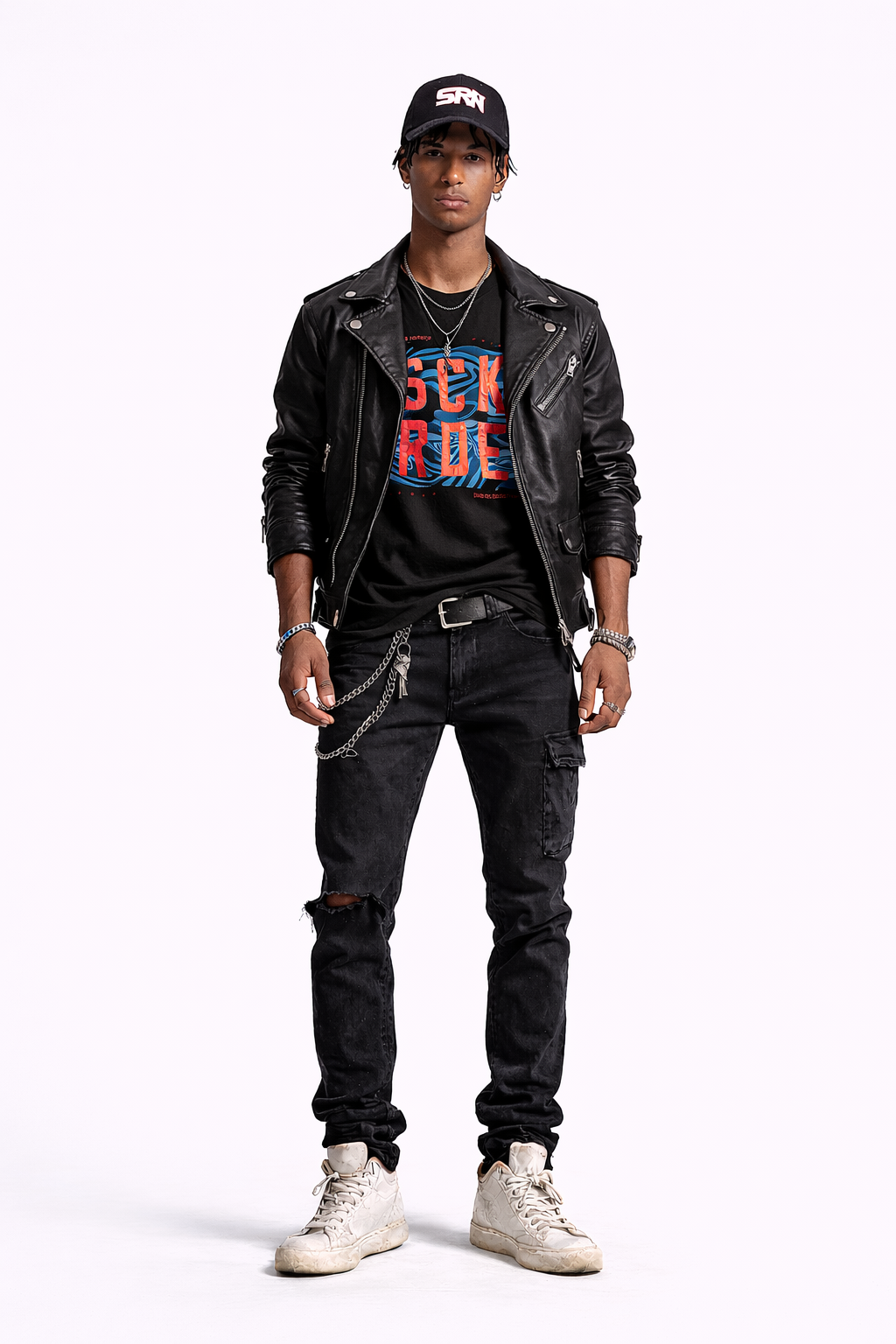 Person wearing a black leather jacket, graphic t-shirt, black jeans, and white sneakers on a white background
