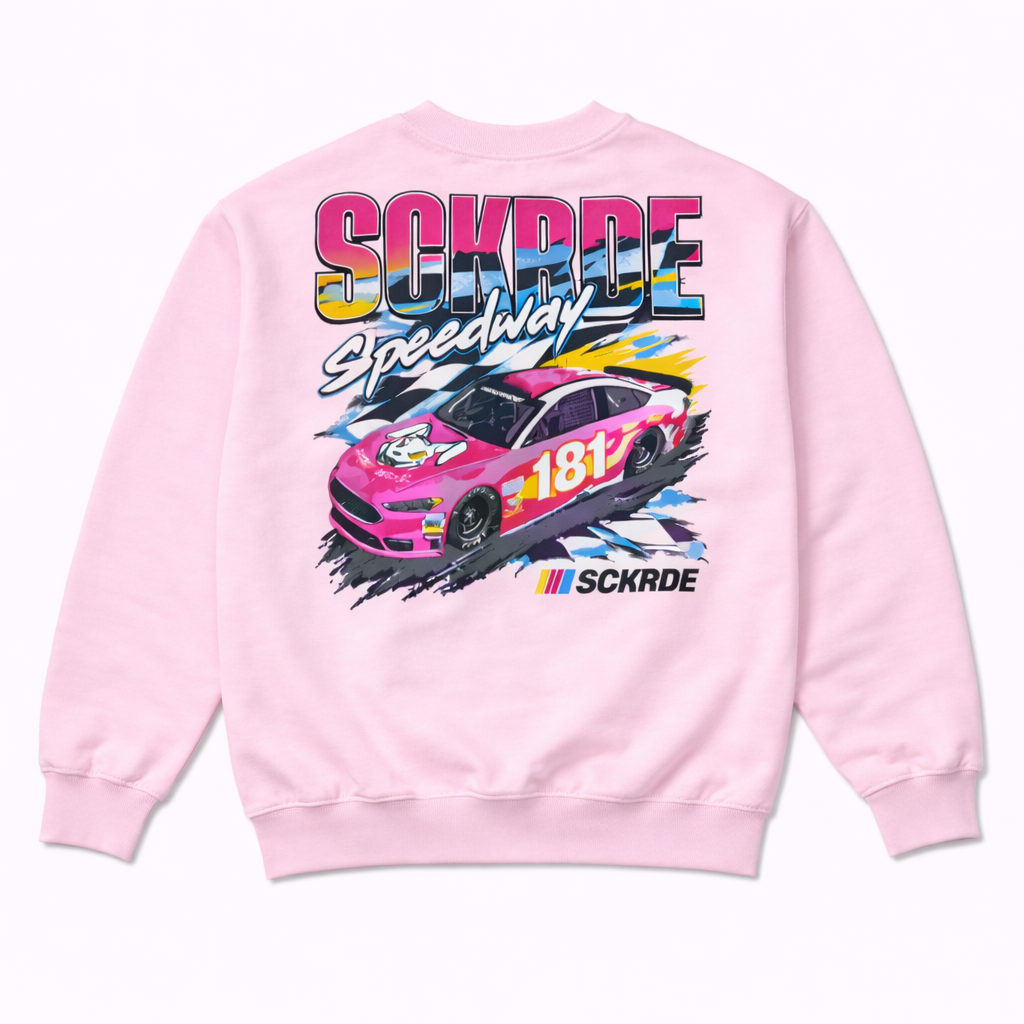 Pink sweatshirt with a race car graphic and 'SCKRDE' branding on a white background