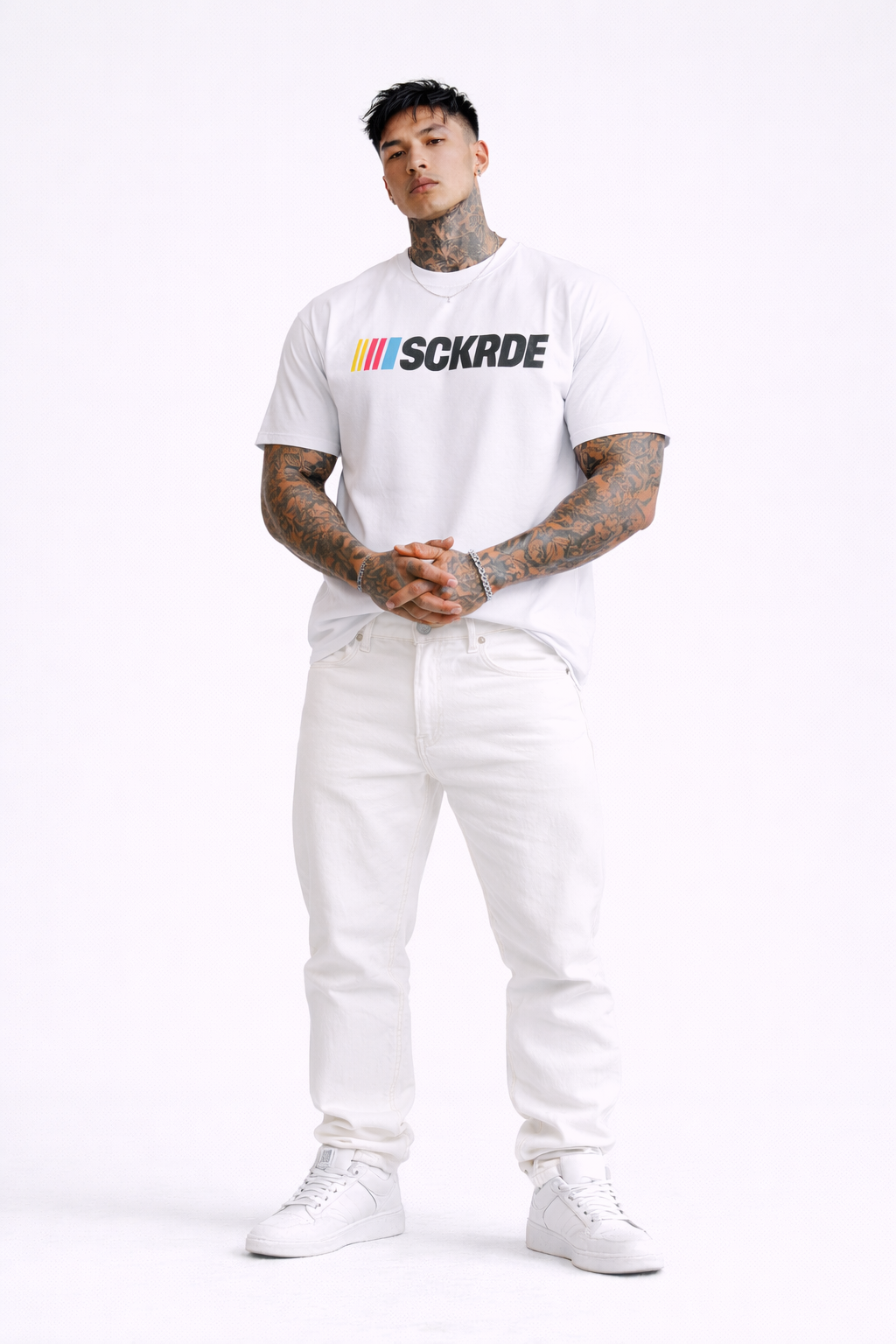 Person wearing a white t-shirt with a logo and text, standing against a white background