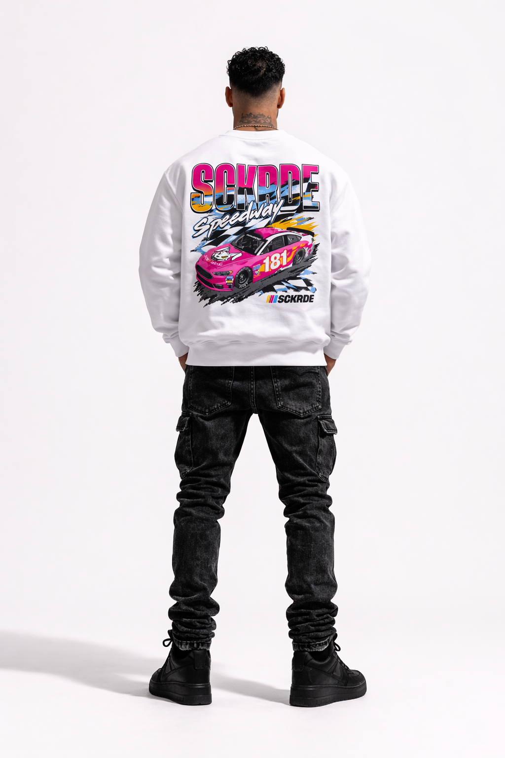 Person wearing a white sweatshirt with a car graphic on the back, standing against a white background