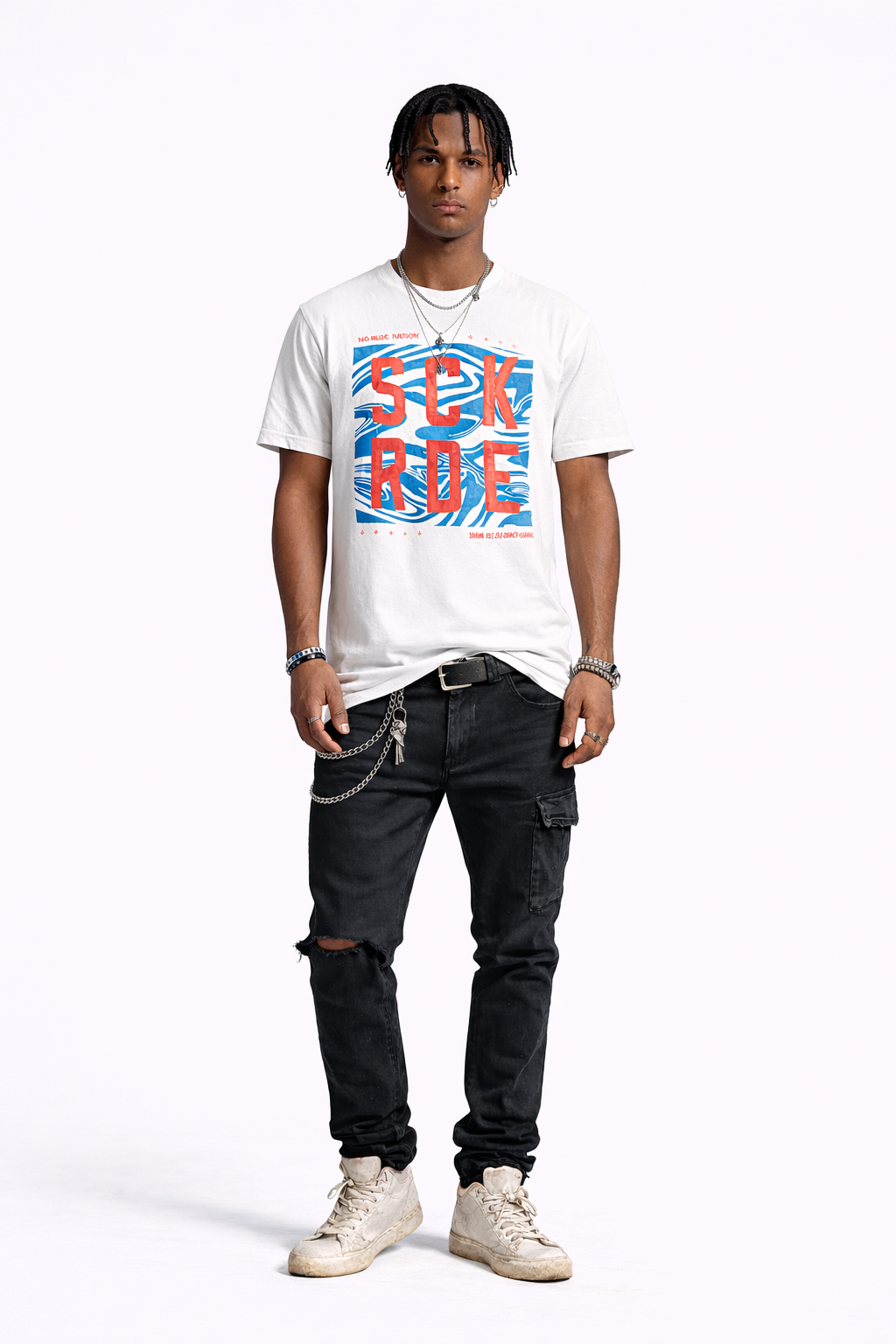 Person wearing a white t-shirt with colorful graphics and dark jeans on a white background