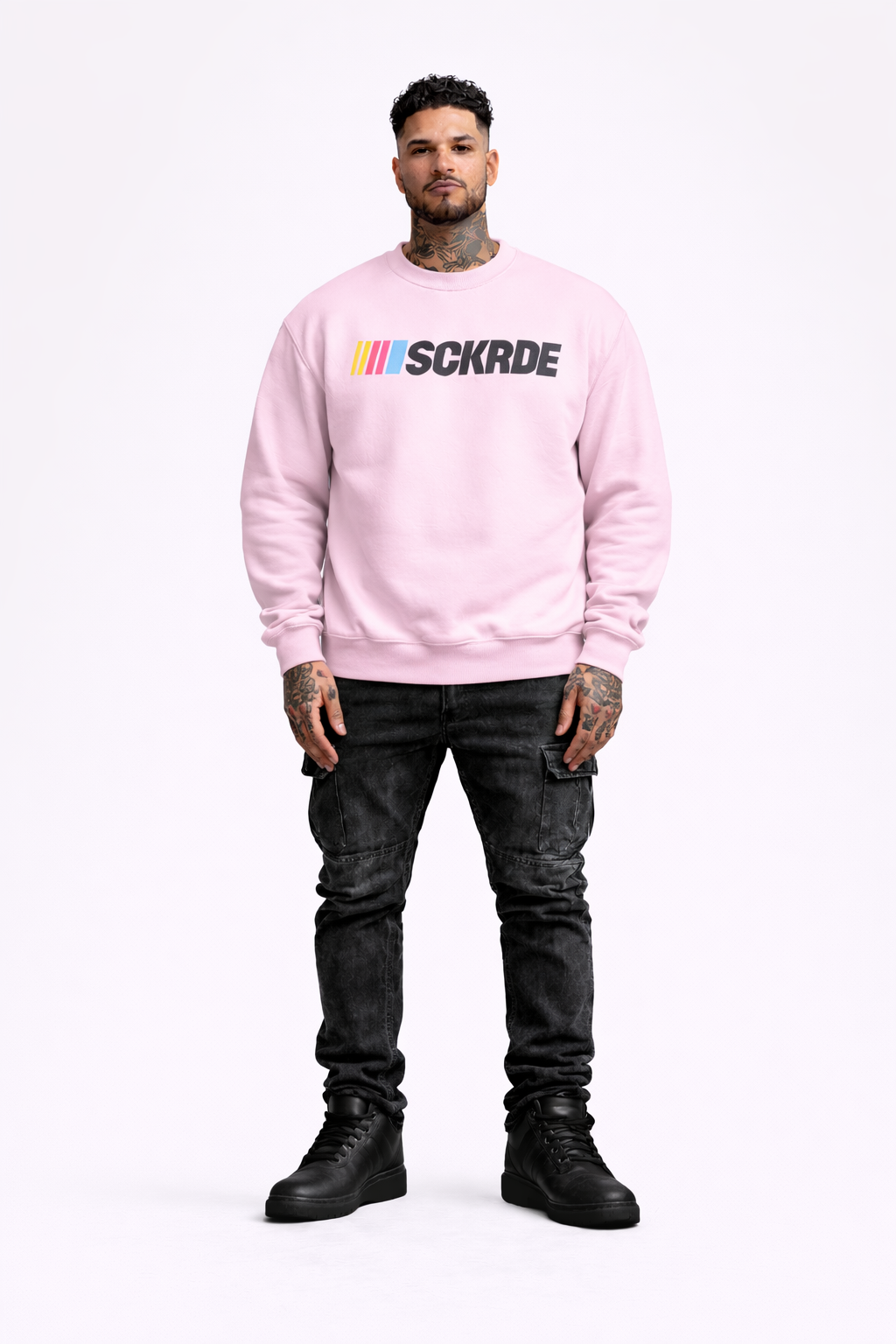 Person wearing a pink sweatshirt with a logo on a white background